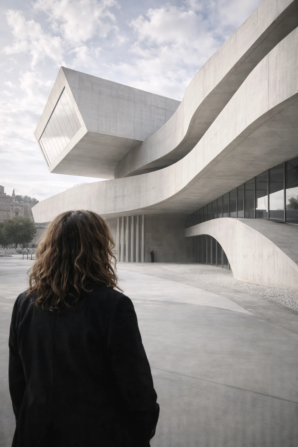 Zaha Hadid contemplating a fluid concrete building